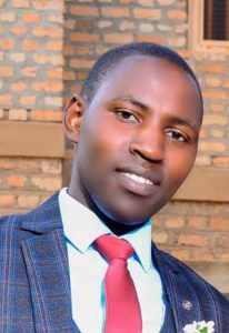 Official portrait of Mr. Twinomujuni Ram, the Assistant Director of Studies at St. John's S.S - Ikumba.