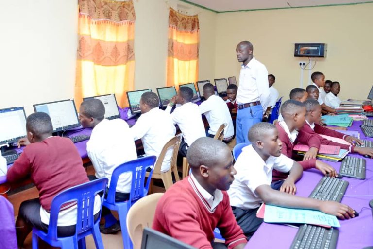 Students attending a practical computer applications class inside the ICT laboratory at St. John's S.S - Ikumba.