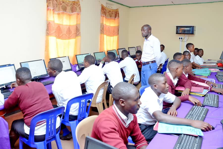 Students attending a practical computer applications class inside the ICT laboratory at St. John's S.S - Ikumba.